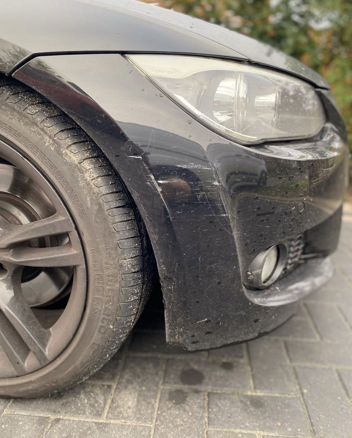 BMW black front bumper before repair - scuff and scrape damage, Camberley