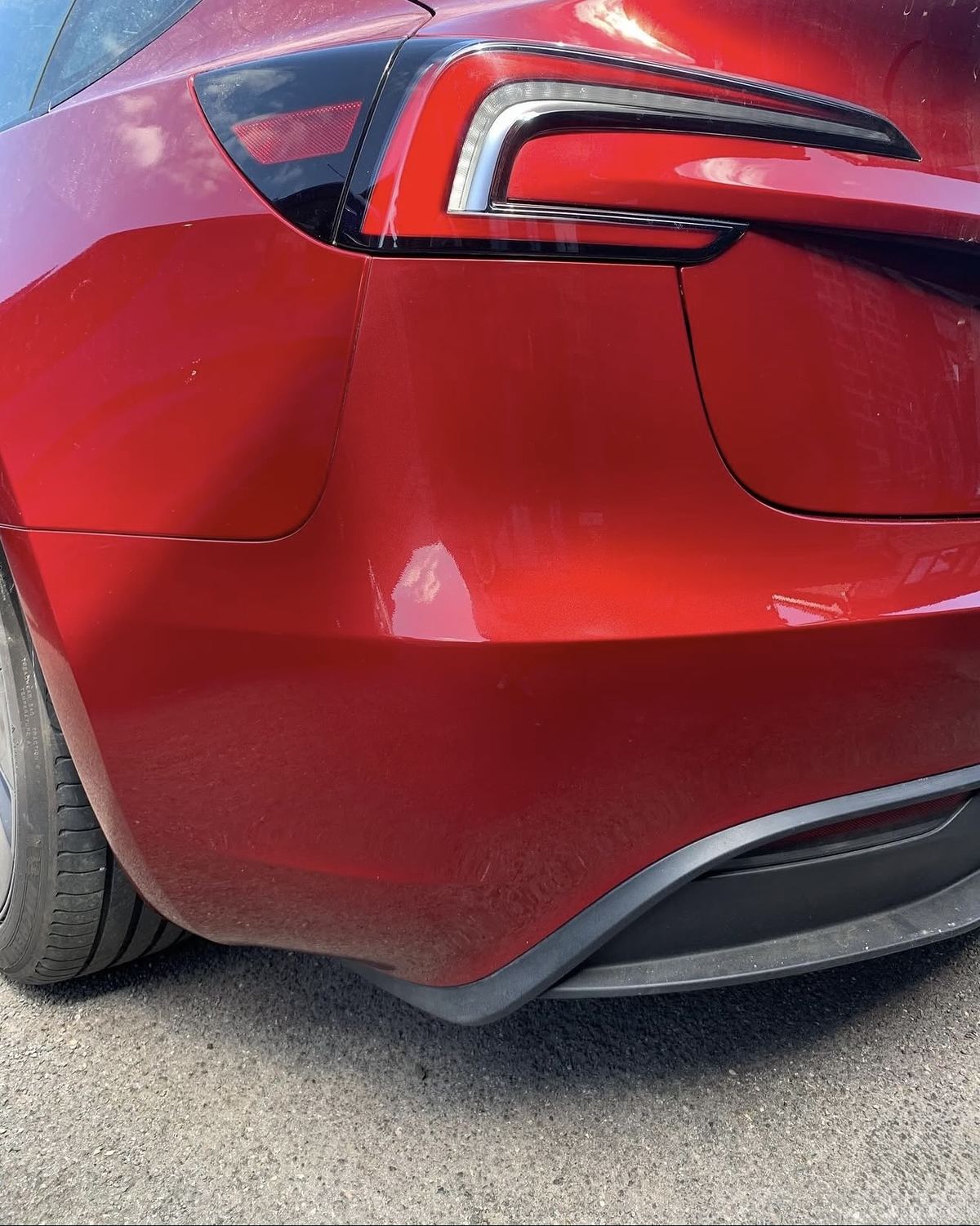 Tesla red rear bumper after repair - 3-stage paint fully restored, Ascot