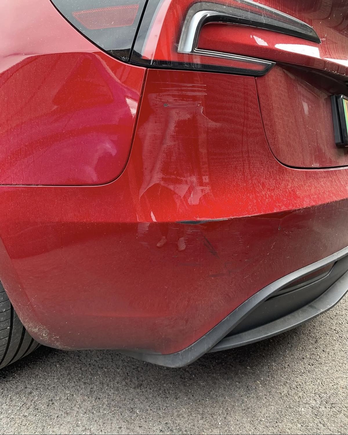 Tesla red rear bumper before repair - scrape damage, Ascot