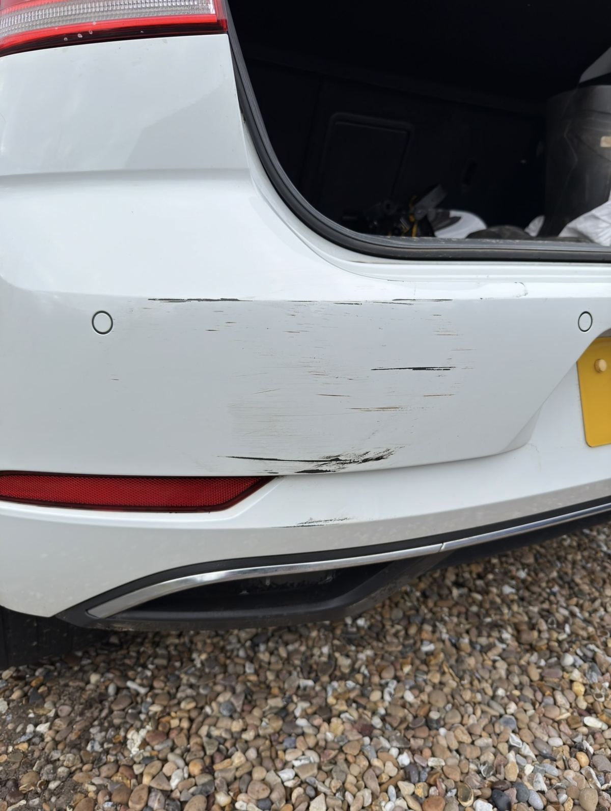 VW Golf white rear bumper before repair - scuff and scrape damage, Guildford